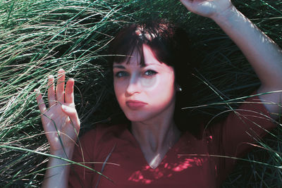 Portrait of woman holding plant