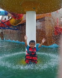 Portrait of boy enjoying at water park