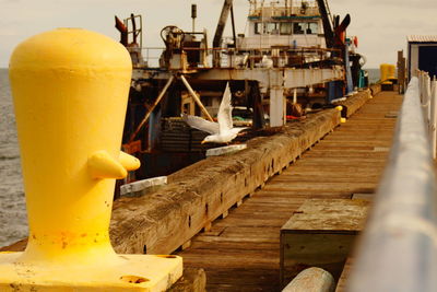 Close-up of yellow container on pier