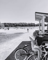 Bicycle on beach against clear sky