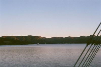 Scenic view of lake against clear blue sky