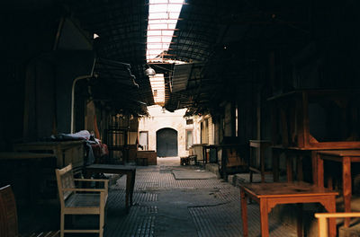 Empty chairs and table in old building