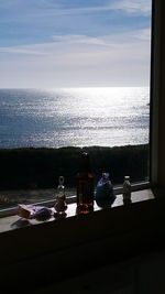 Close-up of table by sea against sky