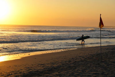 Scenic view of beach against sky during sunset