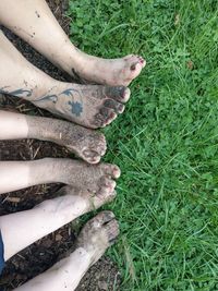 High angle view of messy feet on grassy field