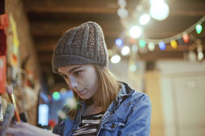 Portrait of woman in illuminated hat