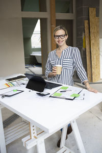 Businesswoman using laptop at office