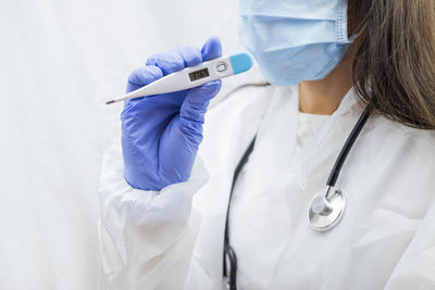 Midsection of doctor examining patient in hospital