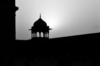 Silhouette built structure against clear sky