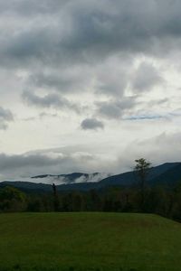 Scenic view of landscape against cloudy sky