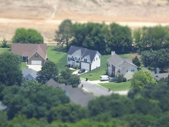 High angle view of houses and trees in city