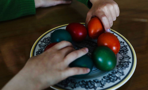 Cropped image of person holding fruits