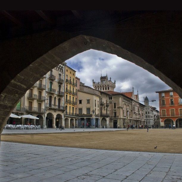 architecture, built structure, building exterior, arch, sky, cloud - sky, city, building, architectural column, indoors, water, street, reflection, day, the way forward, cloud, sunlight, incidental people, walkway, cobblestone