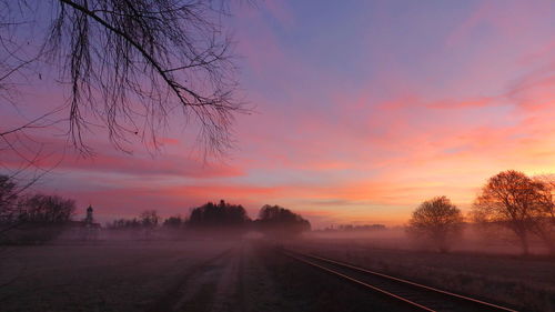 View of railroad tracks against sky during sunset