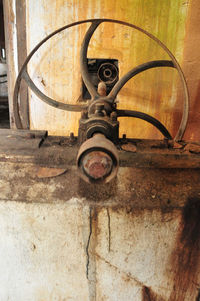 Surface level of old motorcycle parked against wall
