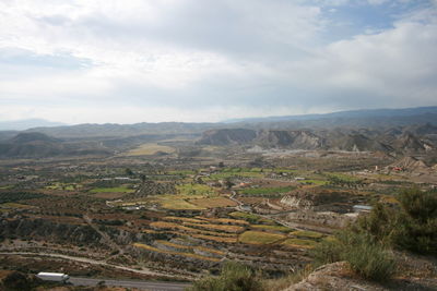 Scenic view of mountains against cloudy sky