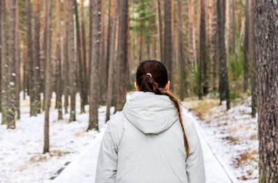 Rear view of woman on snow covered land