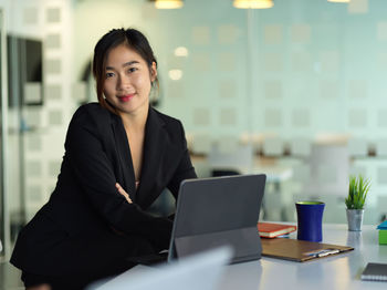 Portrait of smiling young businesswoman in office