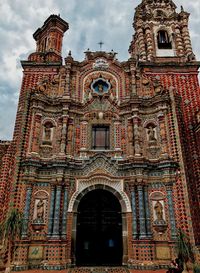 Low angle view of ornate building against sky