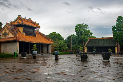 Temple by building against sky