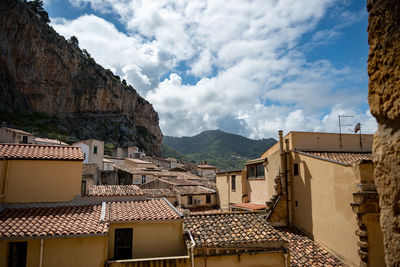 Houses in town against sky