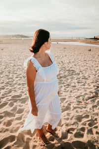 Full length of pregnant woman standing on beach