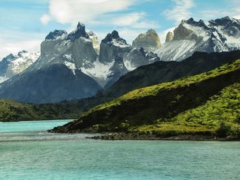 Scenic view of sea and mountains against sky