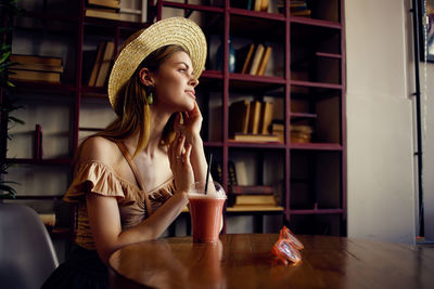 Portrait of woman sitting on table