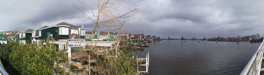 Panoramic view of river and buildings against sky