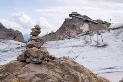 Stack of rocks against sky during winter