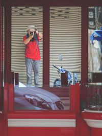 Man photographing with red camera