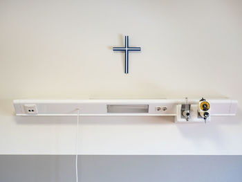 Close-up of electric lamp on wall at home