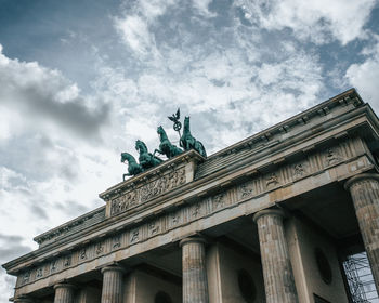 Low angle view of historical building against cloudy sky