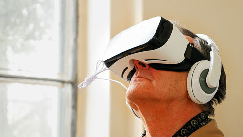 Close-up of senior man wearing virtual reality simulator