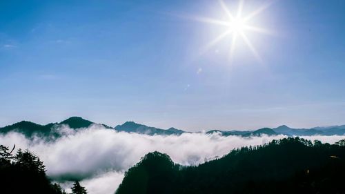 Scenic view of mountains against cloudy sky