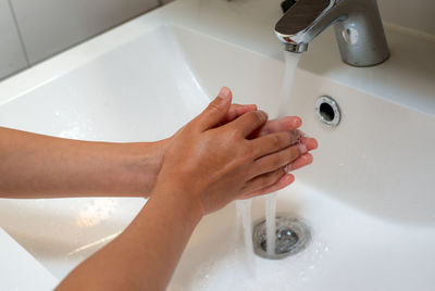 High angle view of hands in bathroom