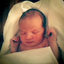 Portrait of cute baby sleeping on bed