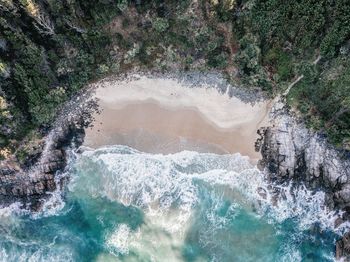 High angle view of water flowing through rocks