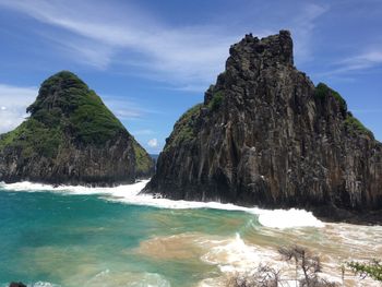 Scenic view of rocks in sea against sky