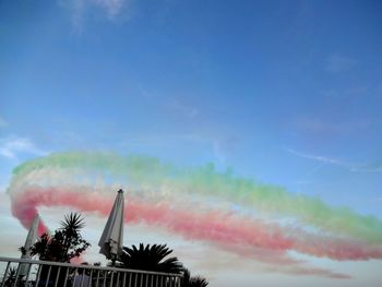 Low angle view of traditional windmill against blue sky