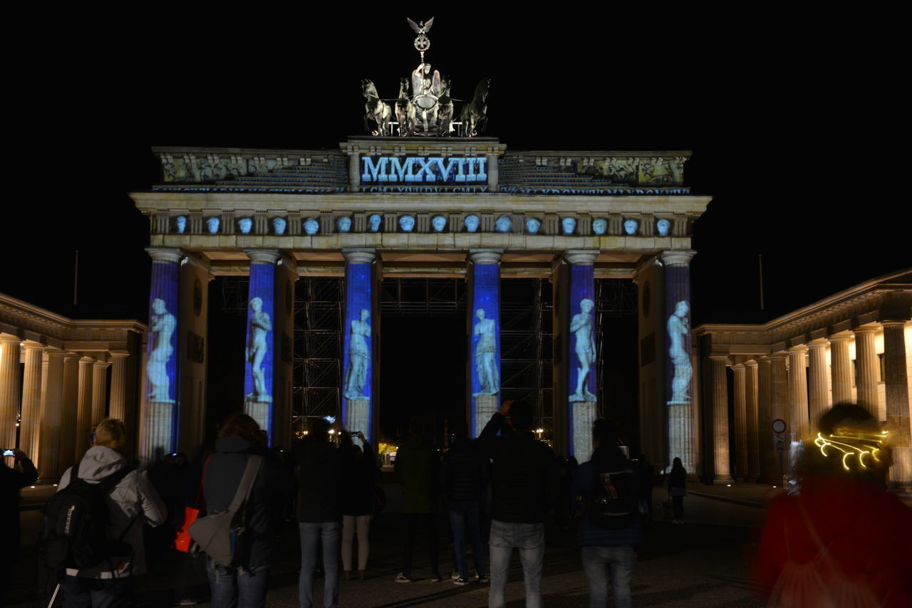 GROUP OF PEOPLE IN FRONT OF BUILDING