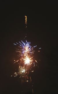 Low angle view of firework display at night