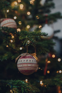 Ornate christmas bauble decoration on a christmas tree, shallow focus, bokeh.