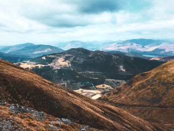 High angle shot of rocky landscape against clouds