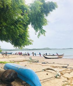 People on beach against sky
