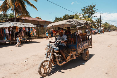 People riding bicycles on road in city