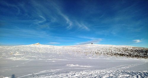 Scenic view of snowcapped mountain against blue sky