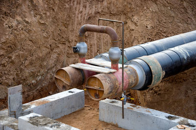 Laying heating pipes in a trench at construction site. installation underground storm system 