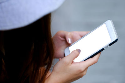 Midsection of woman using mobile phone
