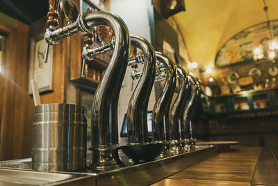 Close-up of beer taps in bar